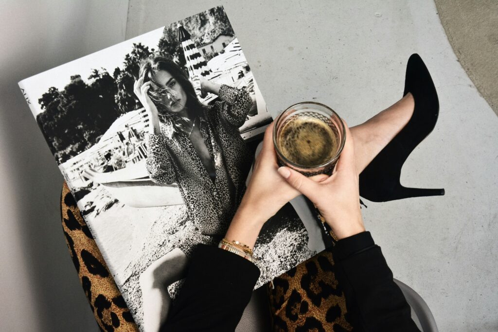 woman in high heels drinking coffee and reading magazine