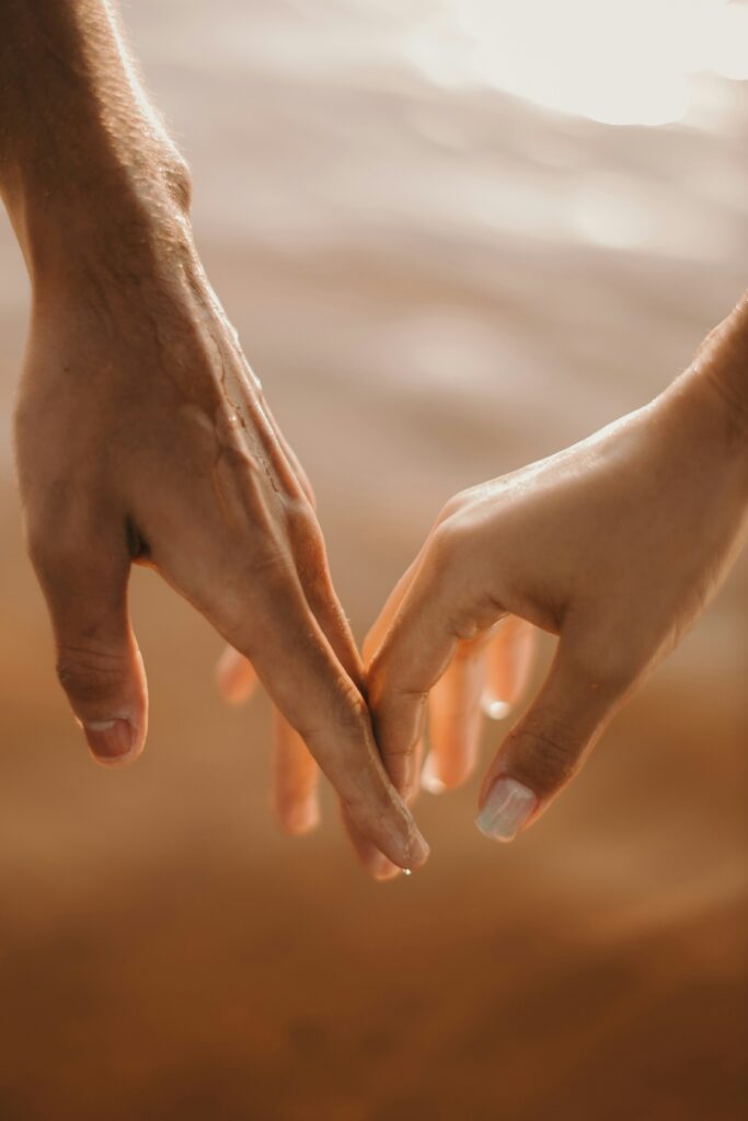 two hands holding each other