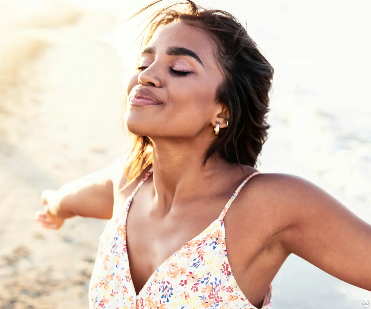 woman in white dress inhale on sunset