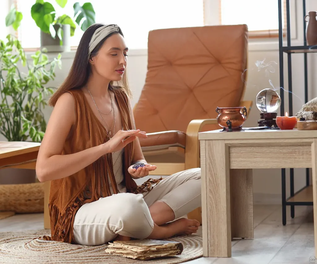 A woman in a brown tunic at a table.